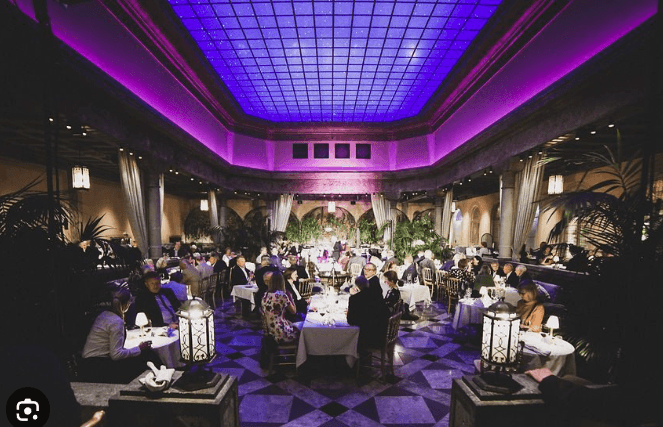 Guests dining in Palmehaven beneath its illuminated ceiling